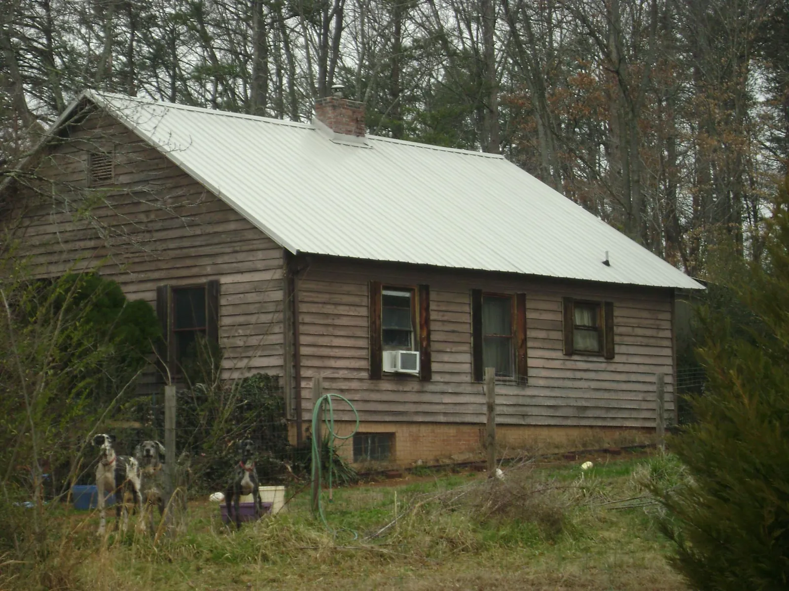 White metal roof on an old wood sided farmhouse, from a Asphalt Shingle Roof Repair job in Zenda